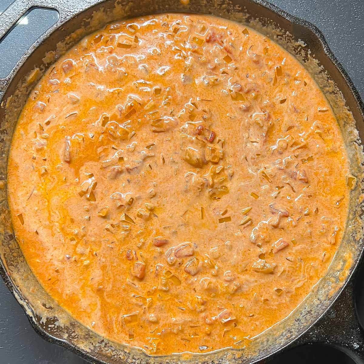 Sauce simmering with sour cream added