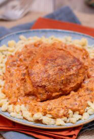 blue plate holding an individual portion of Hungarian Chicken Paprikash with Dumplings