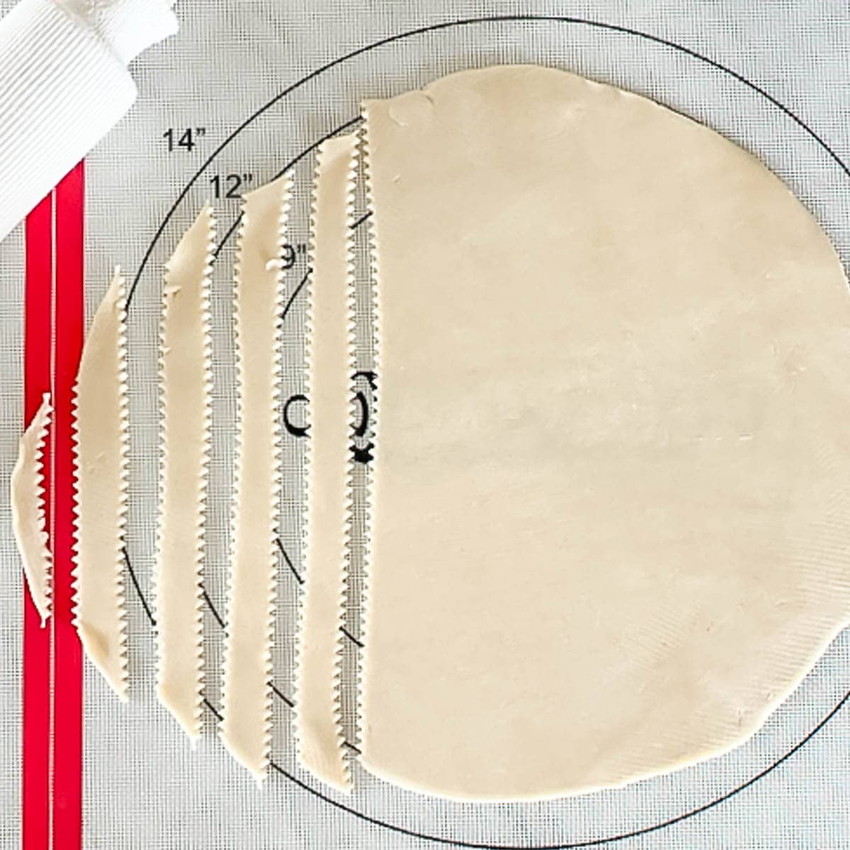 rolled out pie dough, partially cut into strips for lattice top