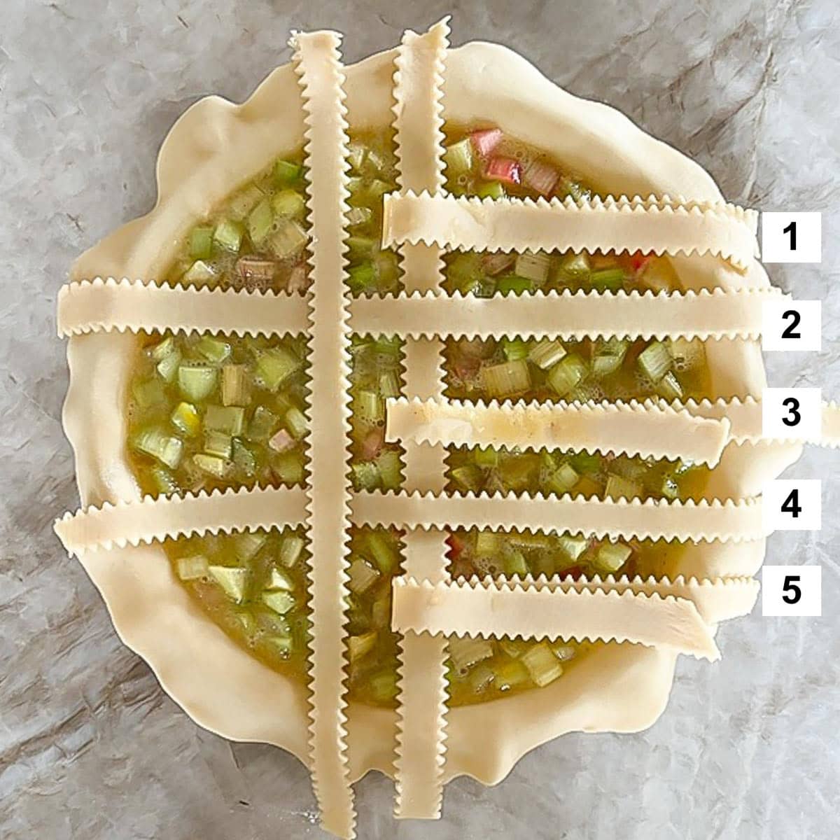 Filled pie with partially woven strips on top, showing step 2 of the weaving process