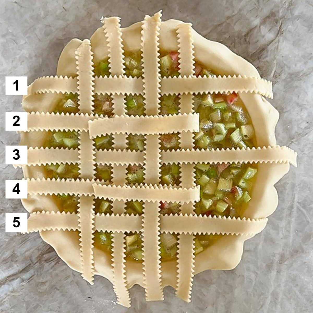 Filled pie with partially woven strips on top, showing step 3 of the weaving process