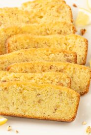 Eight slices of lemon bread, arranged overlapping on a white background.