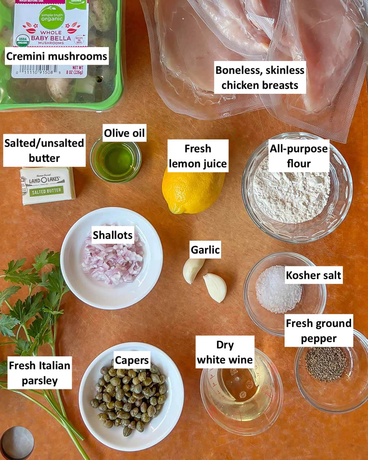 brown board holding all the ingredients in this Lemon Chicken Piccata recipe