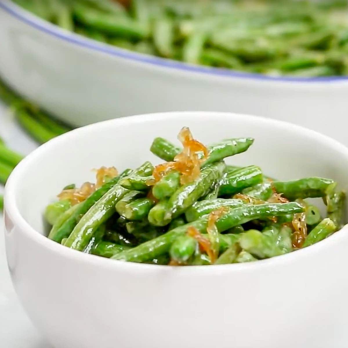 small white bowl holding a portion of oven roasted green beans