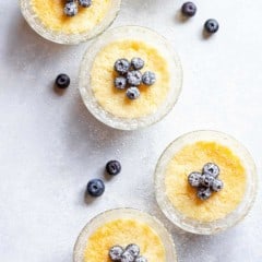 Overhead view of small glass dishes filled with baked Lemon Pudding Cups