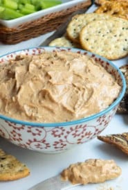 Red and white bowl filled with Liptauer Cheese Spread