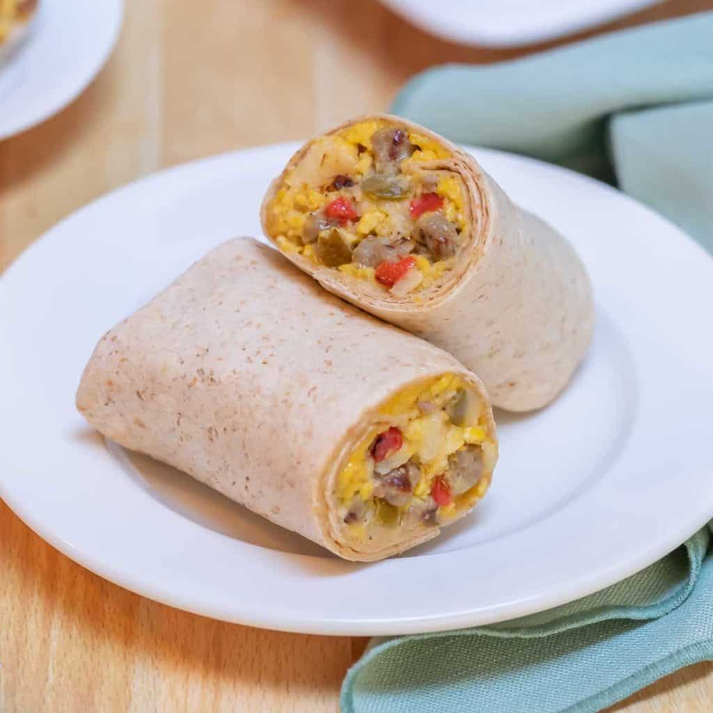 Close up of single Make Ahead Breakfast Burritos, cut in half to show inside