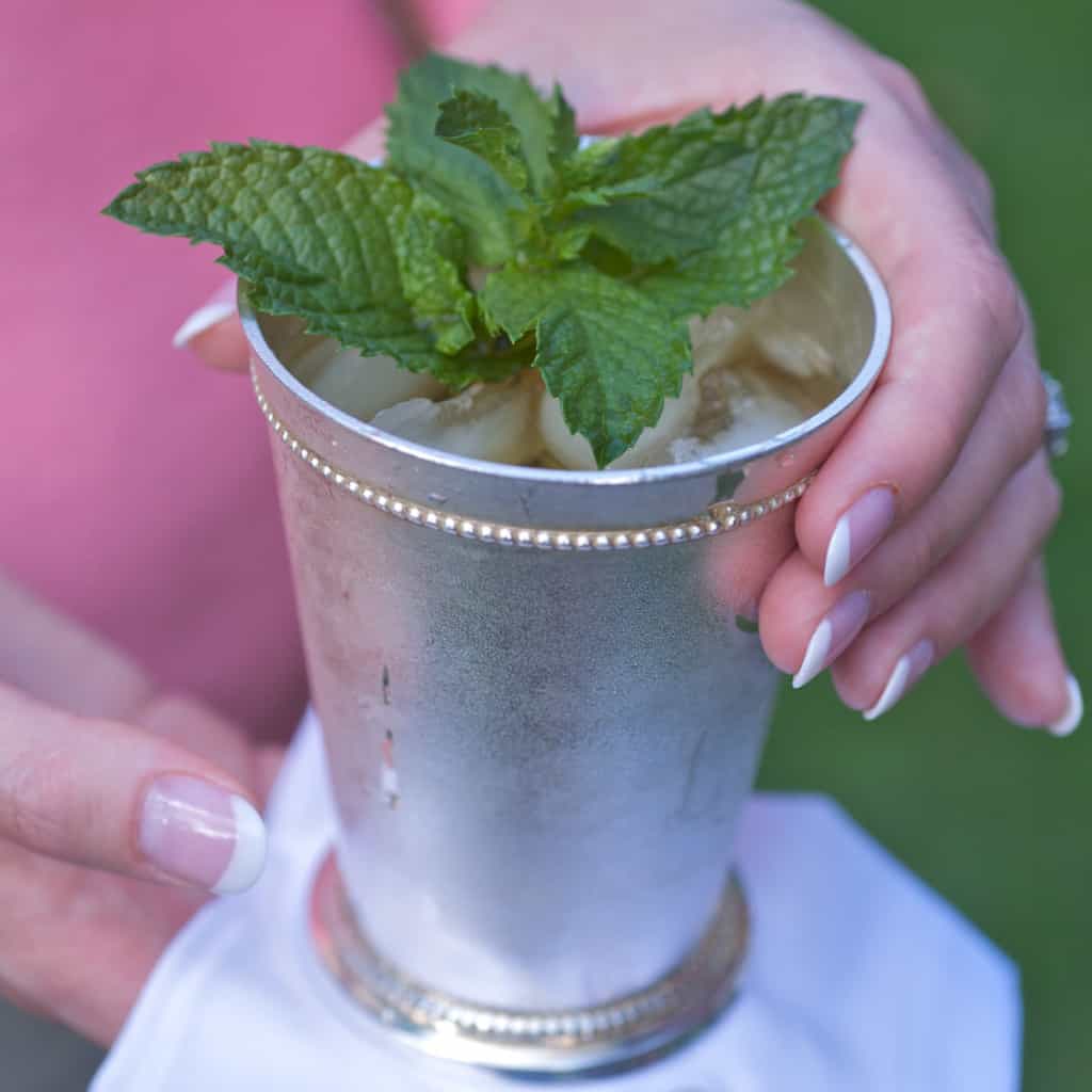 Mint julep cup holding a single serving with a white napkin underneath
