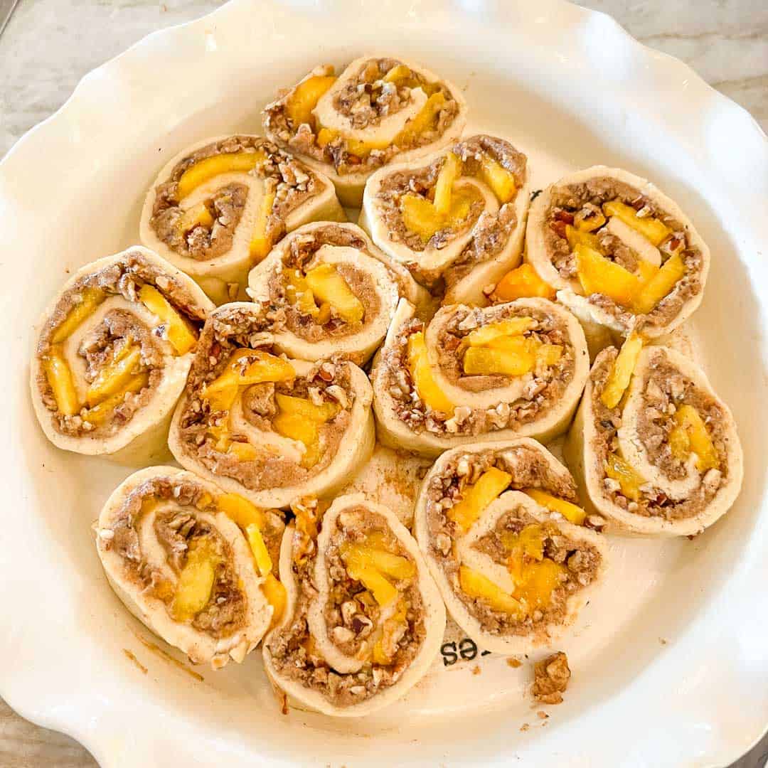 Overhead view of cut rolls in pan before baking