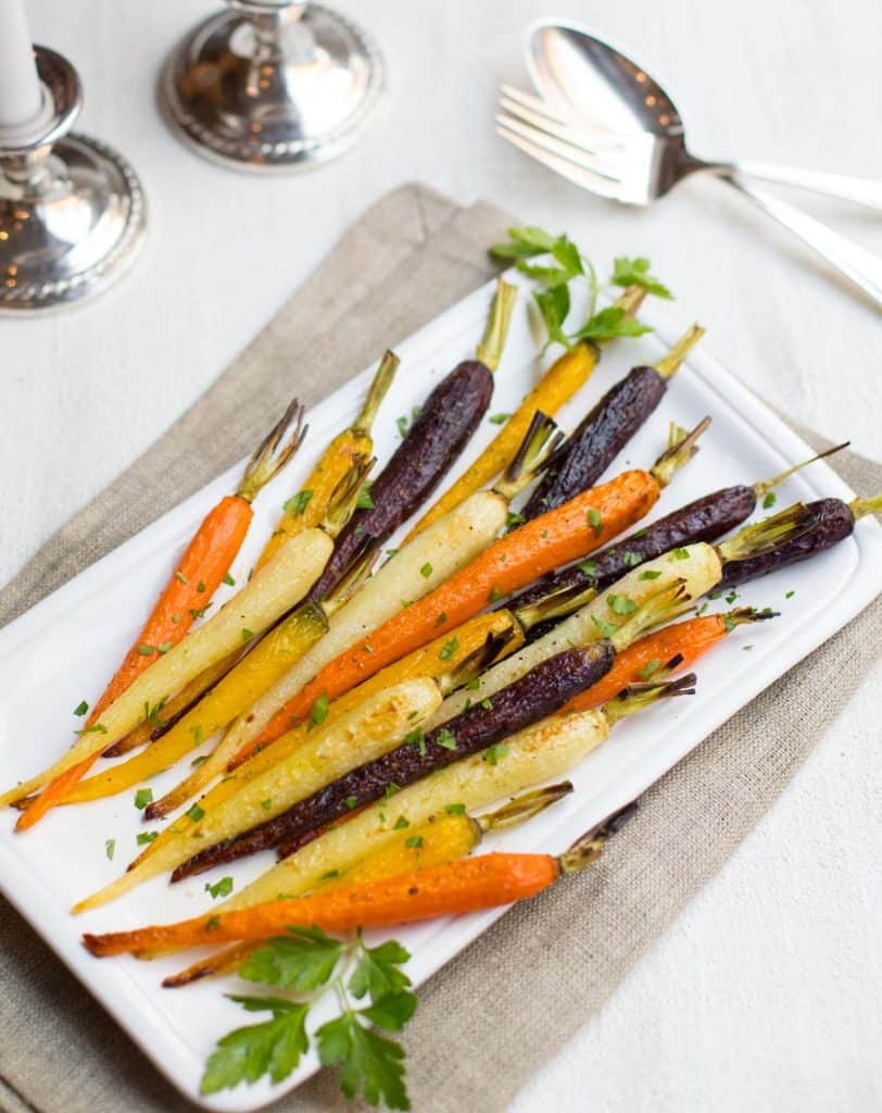 White platter showing rainbow-colored Oven Roasted Carrots