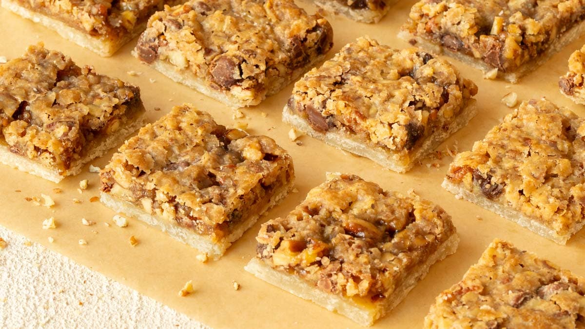 Pecan Pie Bars cut into individual bars on a wooden board, showing the inside of the cookie