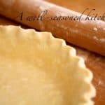 Unbaked pie crust shell with rolling pin