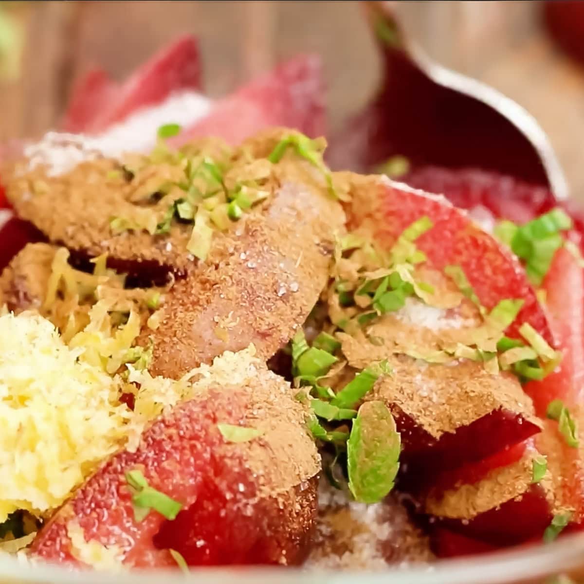 process shot stirring seasonings into plum slices
