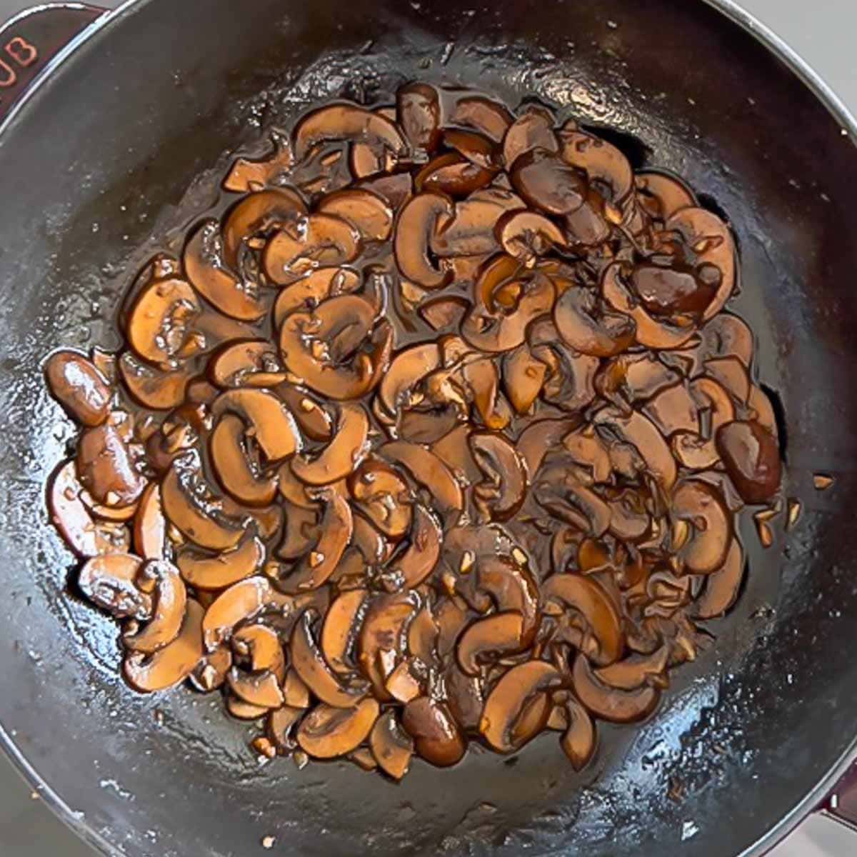 Overhead of mushroom sauce in saute pan, showing what the gravy portion should look like