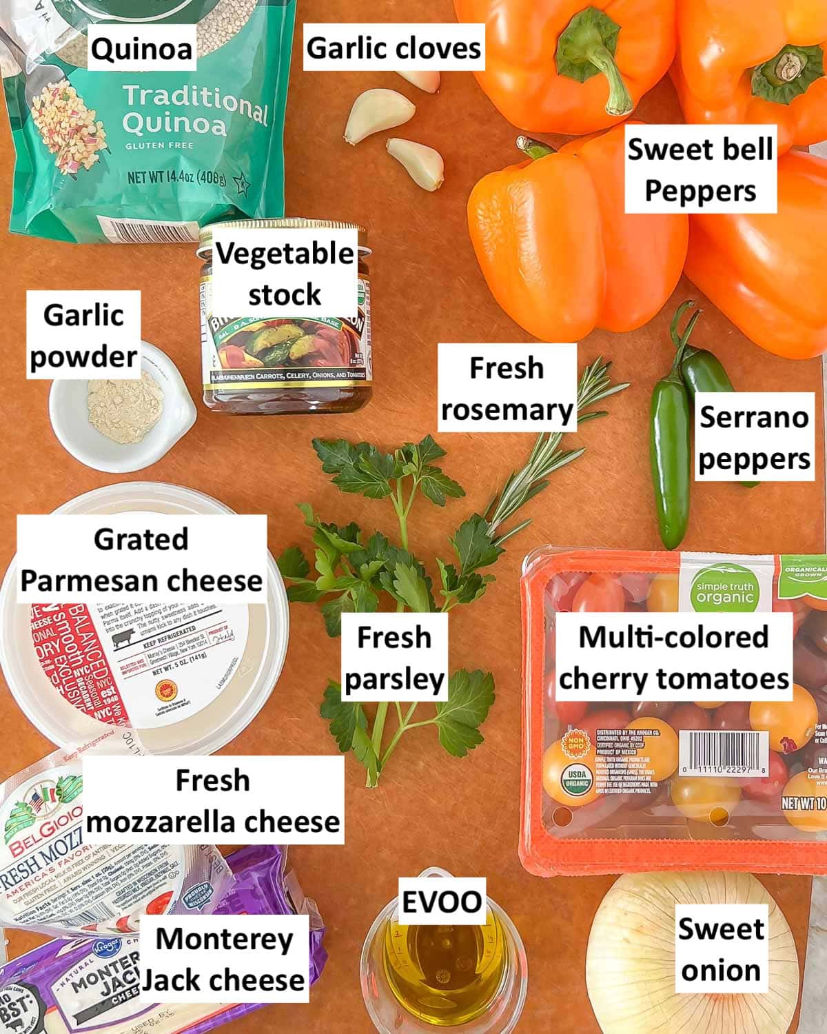 overhead view of all the ingredients with labels (except the canned chickpeas and basil) that are in Quinoa Stuffed Bell Peppers