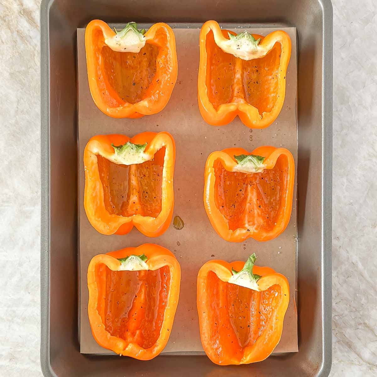 Process shot of 6 orange bell pepper halves ready for stuffing