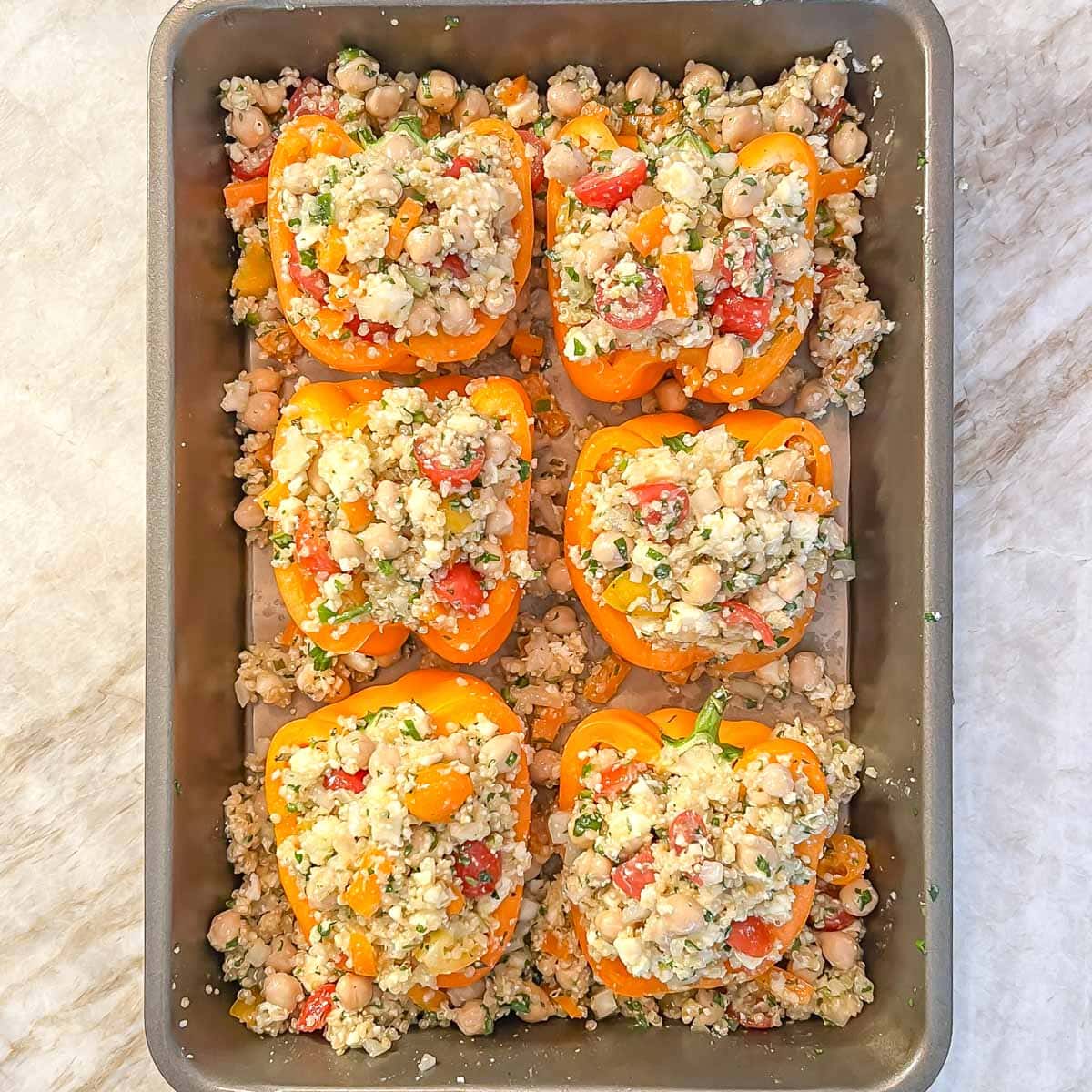 Process shot of quinoa stuffed peppers without the cheese and ready for baking
