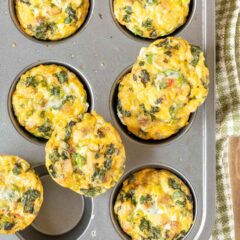 Overhead view of Sausage, Egg and Cheese Muffins in muffin pan, with 3 muffins sitting on top