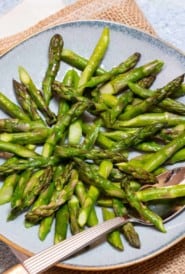 Blue plate filled with Quick and Easy Sauteed Asparagus
