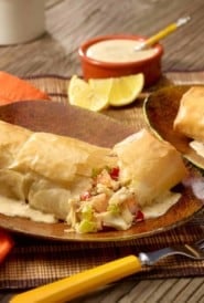 Brown plate with a Seafood Phyllo Bundle broken in half