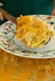 Scoop of crab and shrimp lasagna above dish