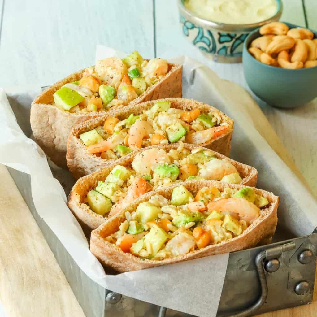 Rice, Shrimp and Avocado Salad stuffed inside pita bread halves, which are sitting in a metal box