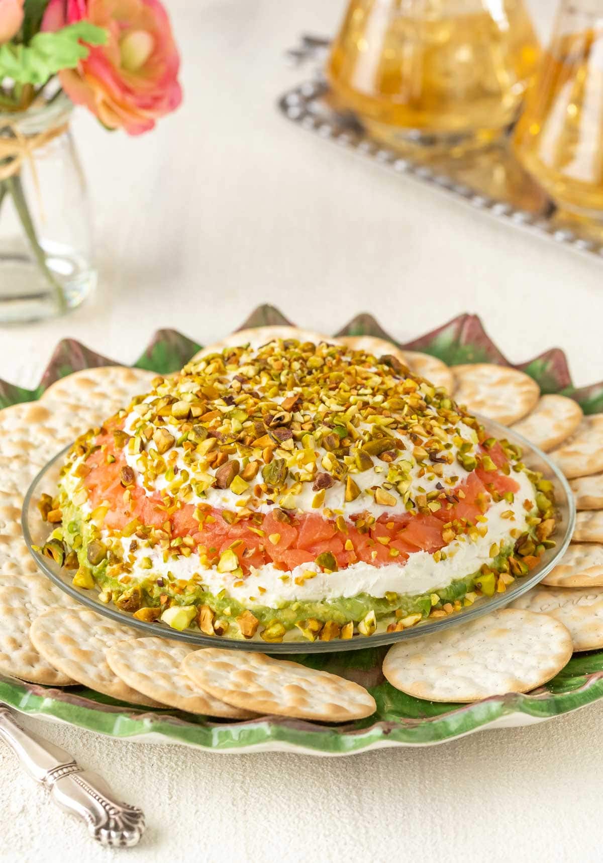 Smoked Salmon Cream Cheese Spread with Avocado on a serving platter surrounded by crackers