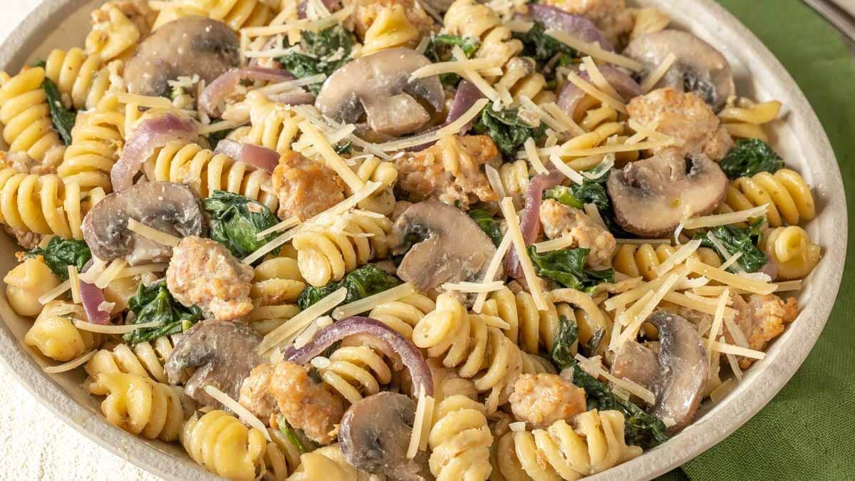 Close up view clearly showing the ingredieints in this Chicken Sausage, Spinach, and Mushroom Pasta