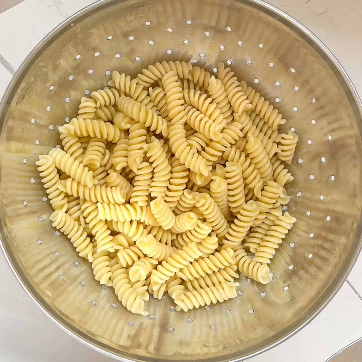 cooked pasta draining in a colander