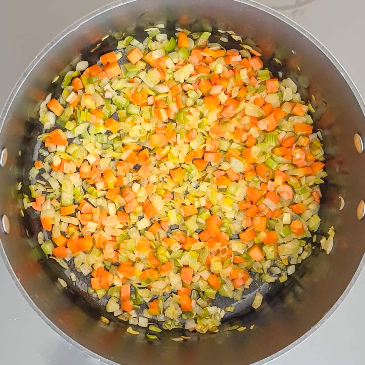 overhead view of vegetables cooking in a skillet. Shows when they are done.