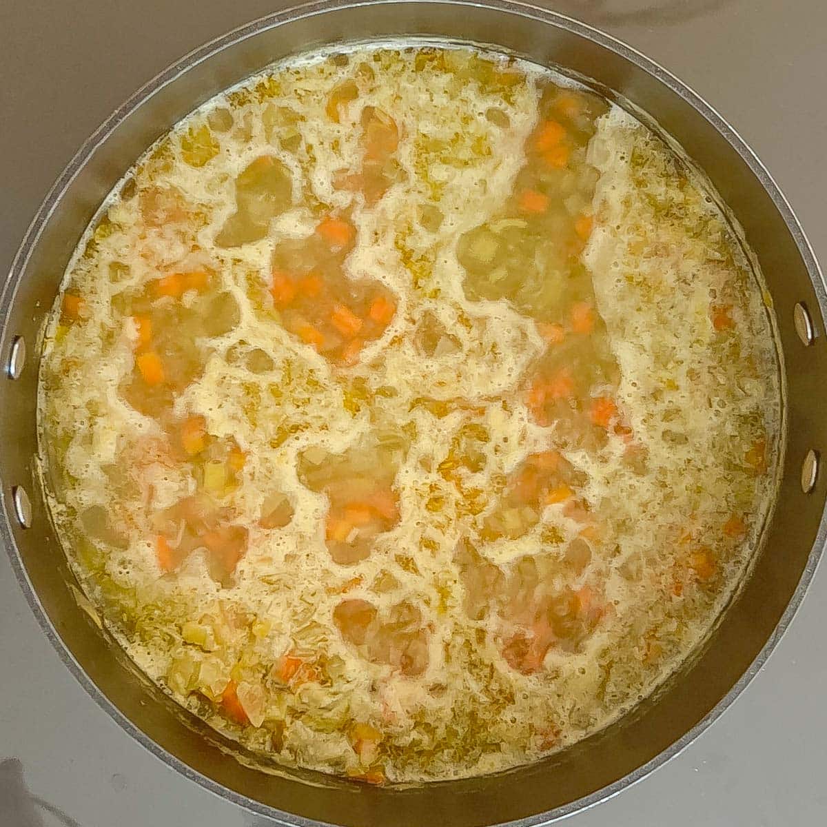 overhead view of split pea soup simmering