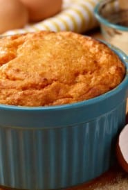 Blue souffle dish filled with Brandied Sweet Potato Souffle
