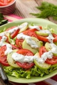 Sliced tomatoes and cucumbers with yogurt-mint dressing