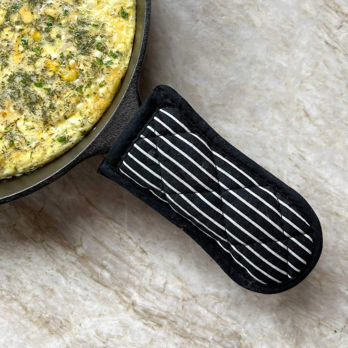 skillet handle mitt (a padded handle) that protects the cook from grabbing a hot skillet handle