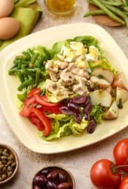 Single serving of tuna salad nicoise on an ivory plate