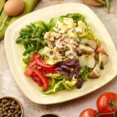 Single serving of tuna salad nicoise on an ivory plate