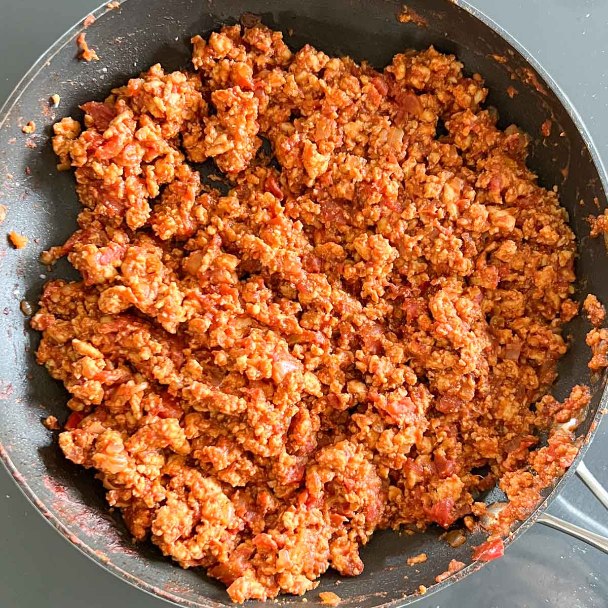 ground turkey with sauce cooking in skillet