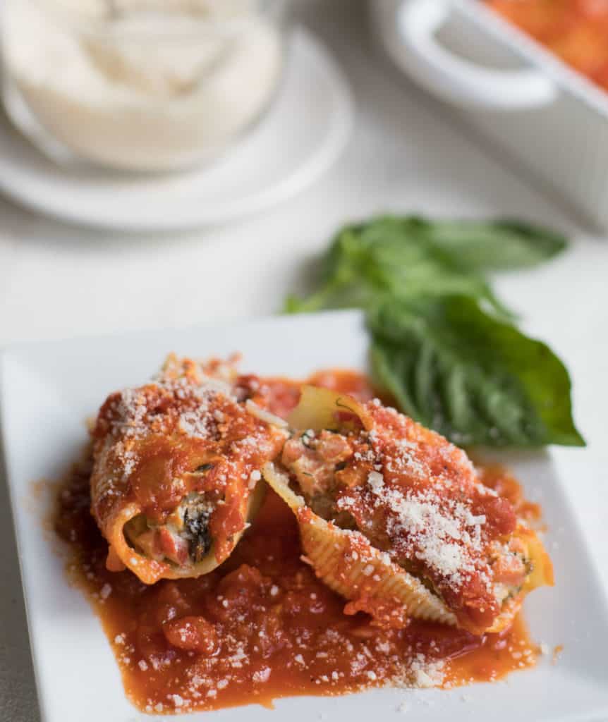 close up image of 2 pasta shells stuffed with turkey and vegetables