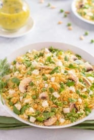 white bowl showing Vegetable Couscous, with Dill Vinaigrette on the side