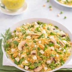 white bowl showing Vegetable Couscous, with Dill Vinaigrette on the side