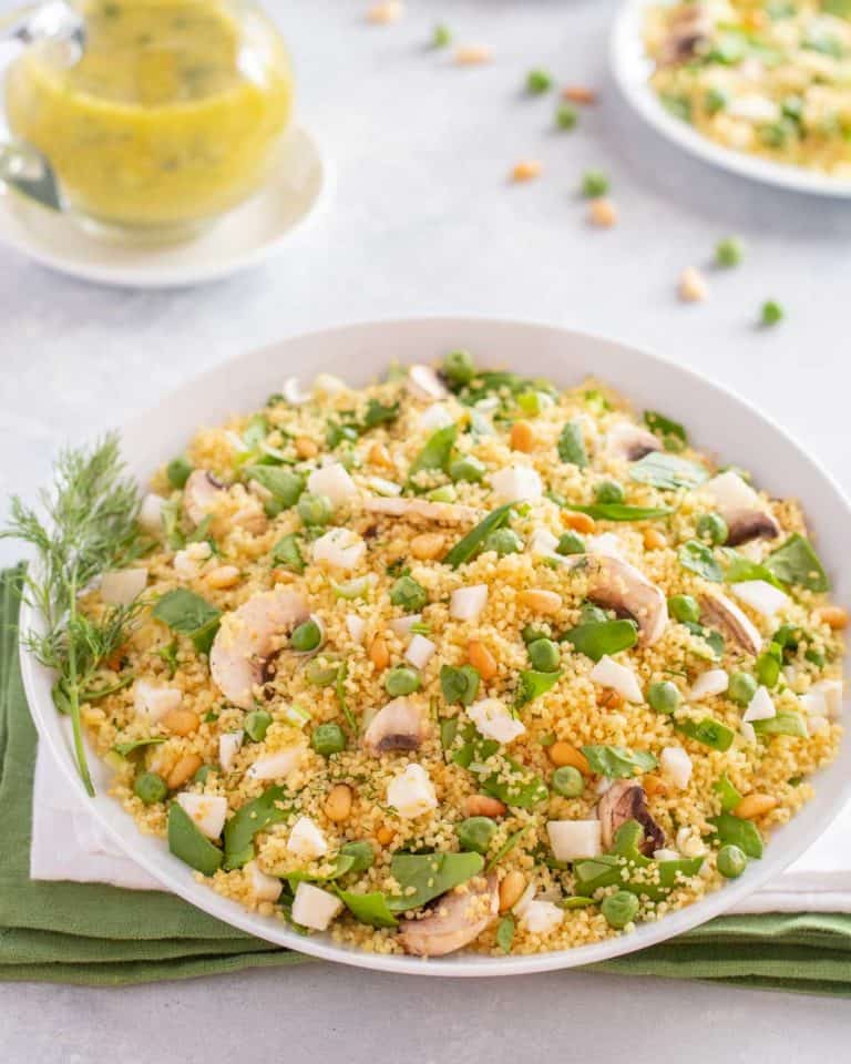 white bowl showing Vegetable Couscous, with Dill Vinaigrette on the side