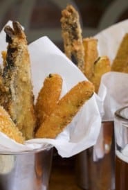 Siver cups filled with Veggie Fries in a napkin, with Lemon-Garlic Aioli on the side