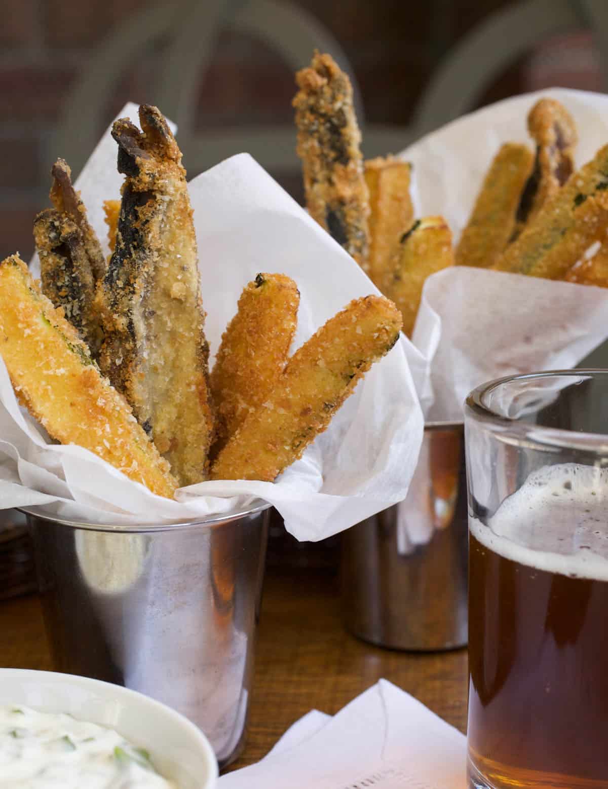 Siver cups filled with Veggie Fries in a napkin, with Lemon-Garlic Aioli on the side