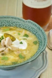 White Bean and Chicken Chili in a blue bowl with a mug of beer